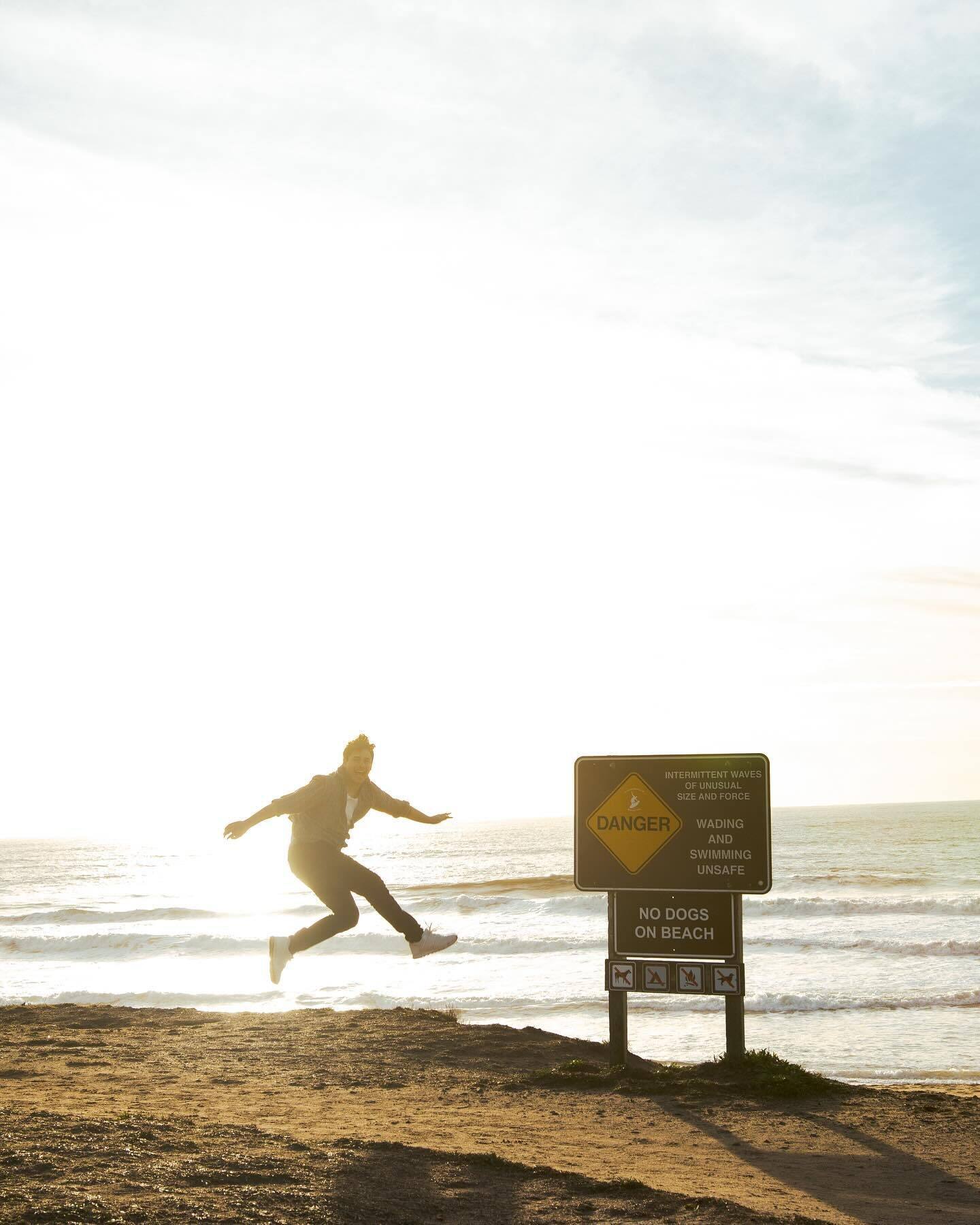 The same leap beside the warning sign, in colour